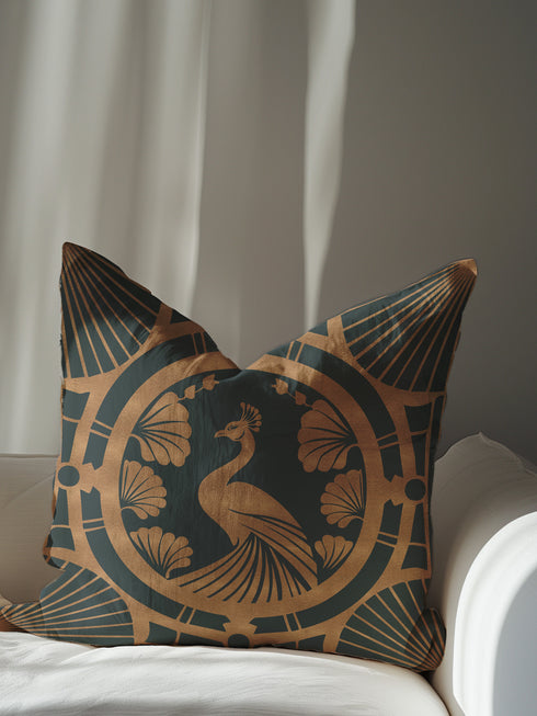 Square pillow cover featuring a stylized copper peacock design centered in a medallion, surrounded by Art Deco fan patterns and shell motifs on a dark forest green background.